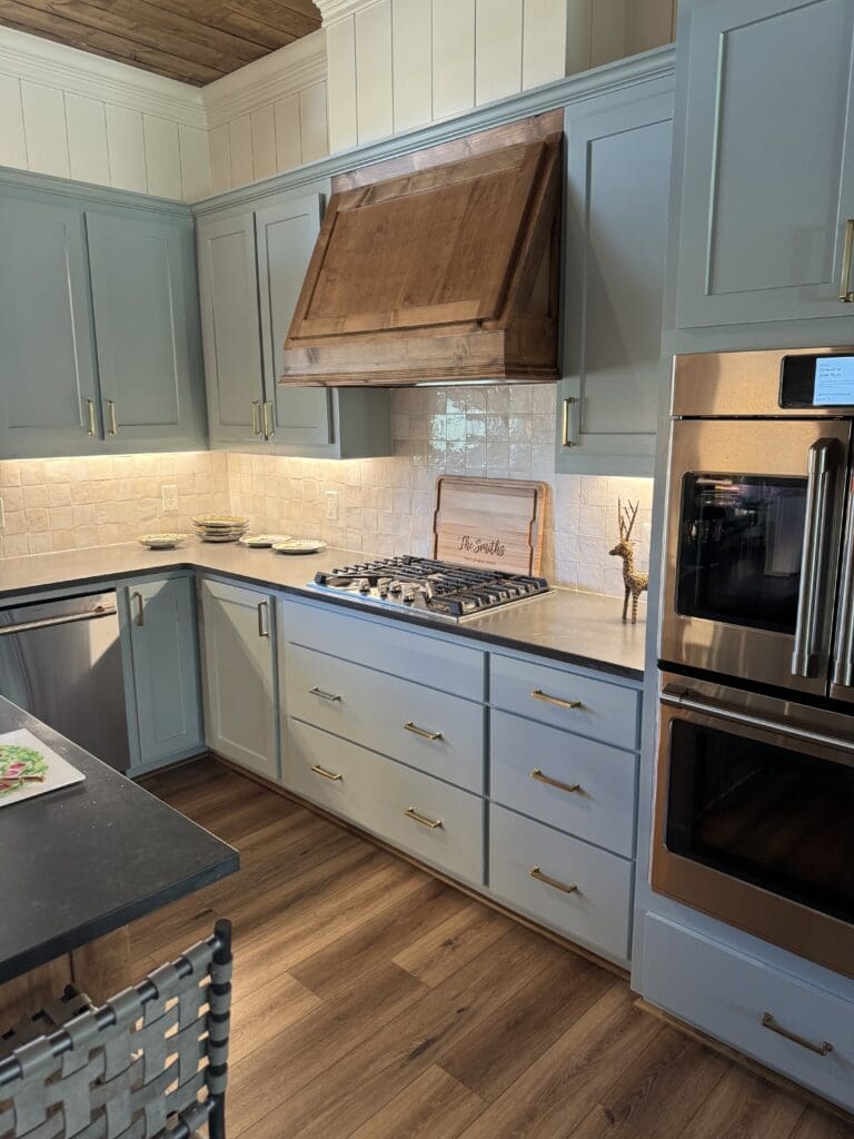 Modern kitchen with wooden range hood.